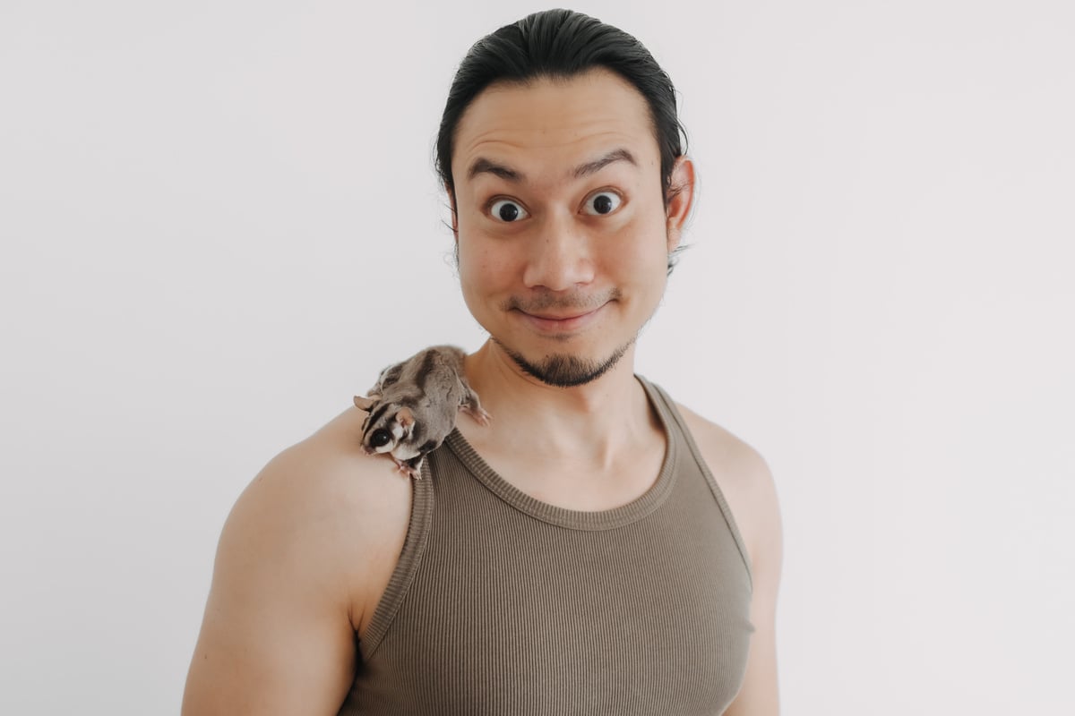 Happy Man in Tank Top with His Cute Pet Sugar Glider.