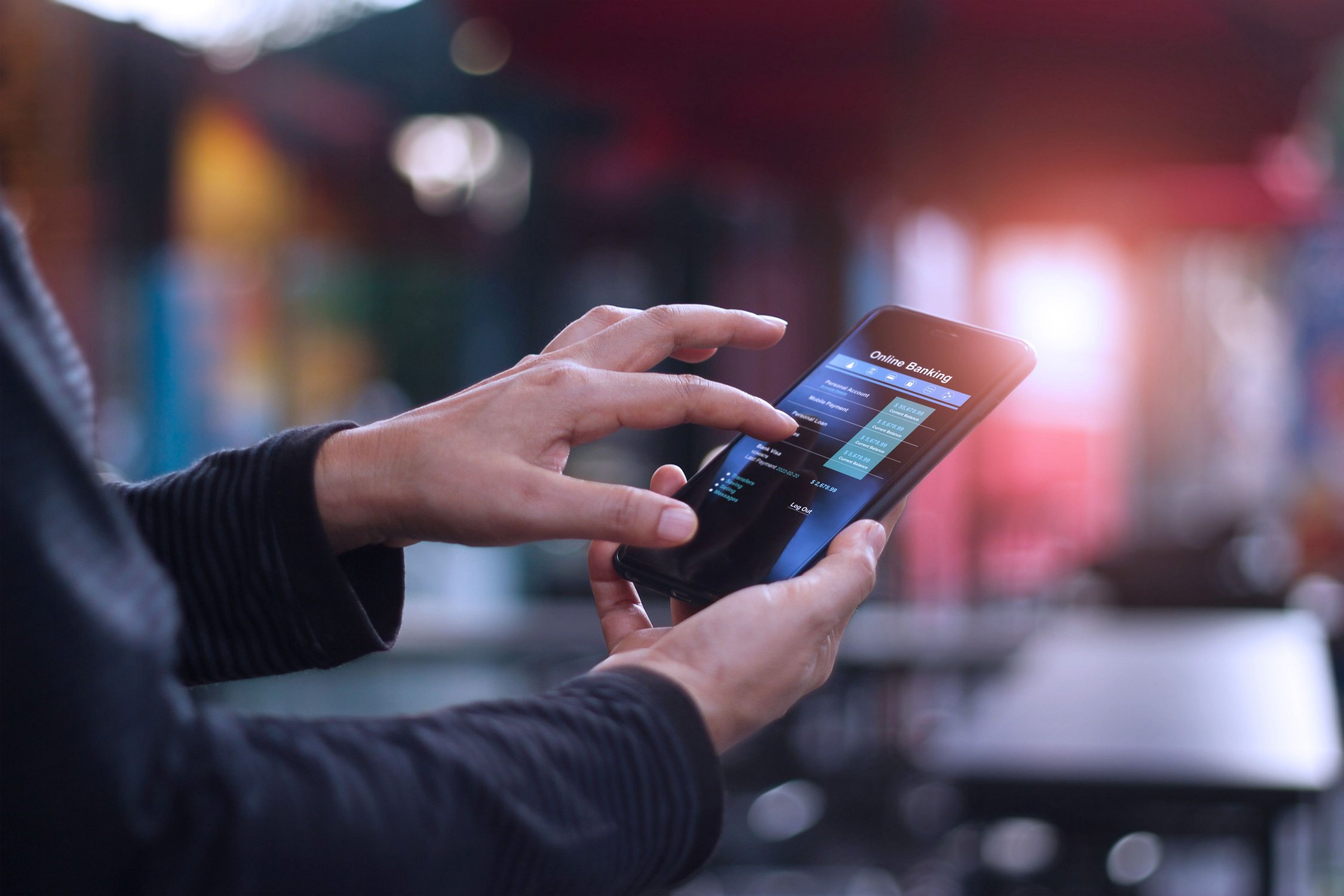 Hand holding a smartphone with a mobile payments payment form on its screen