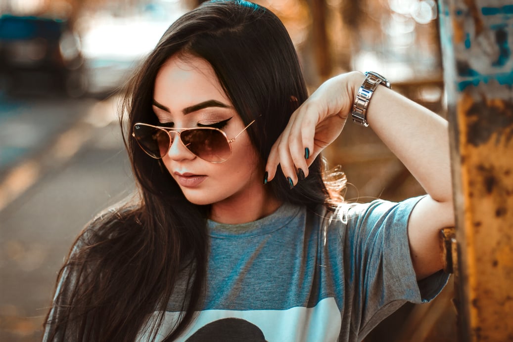 Woman in Grey T-shirt Resting Elbow on Metal Panel