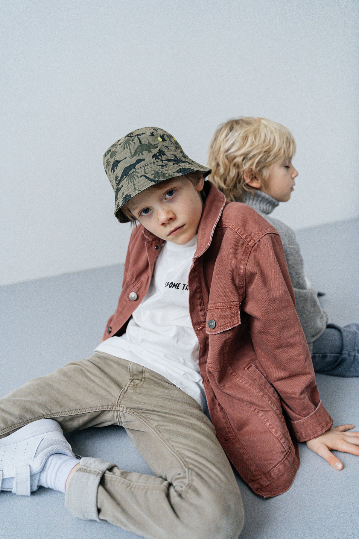 Boy in a Jacket Sitting on the Floor