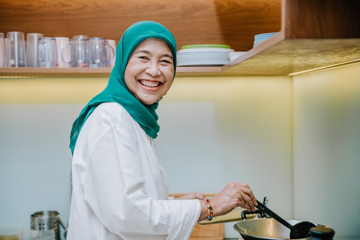 Mature Woman Cooking Indonesian Chicken Curry