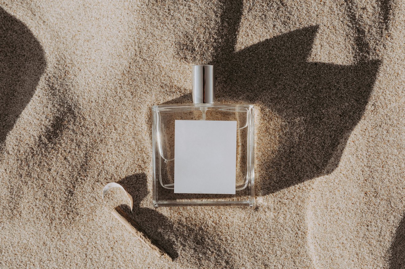 Clear Glass Perfume Bottle on White Sand